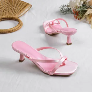 Detailed view of pink satin thong sandals with elegant kitten heels and square toe design