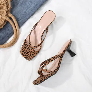 Close-up detail of leopard print thong sandals with kitten heel and square toe design