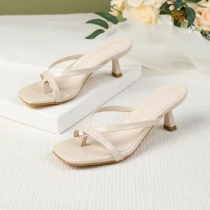 Elegant beige square toe thong sandals with kitten heels and thin straps.