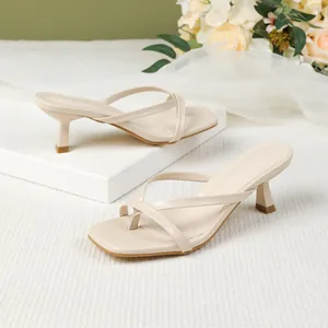 Elegant beige kitten heel thong sandals with square toe and strappy cross details.