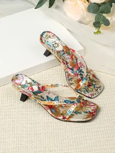 Detailed view of the vibrant floral print on square-toe kitten heel thong sandals
