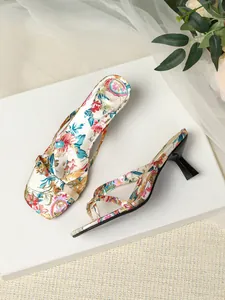 Detailed view of floral pattern kitten heel mules with elegant square toe design.