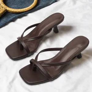 Elegant dark brown square toe thong sandals with kitten heels shown on white fabric