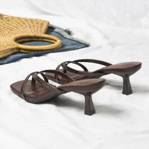 Detailed view of brown stiletto thong sandals with multiple thin straps and square toe.