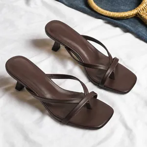 Close-up of brown thong kitten heel sandals with square toe and cross strap design