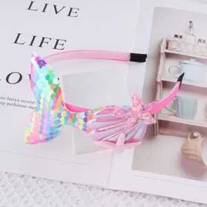 Close-up of pink mermaid tail headband with shiny sequins and shell detail
