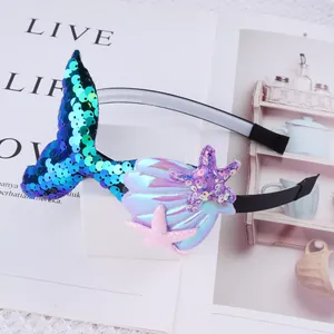 Detailed macro shot of mermaid tail headband featuring shiny sequins, iridescent shells and starfish.