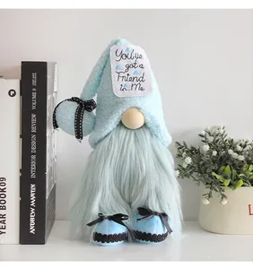 Close-up view of a soft blue plush gnome doll featuring an embroidered decorative hat