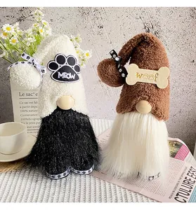 Detail of two adorable plush gnome dolls with pet-themed hats for desktop decoration.