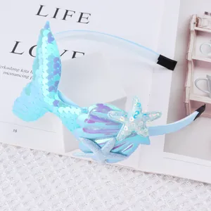 Detailed view of the sequin mermaid tail and shell decorations on a blue headband