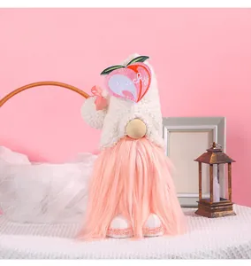 Close-up of a cute plush gnome doll featuring a peach patch and soft pink beard
