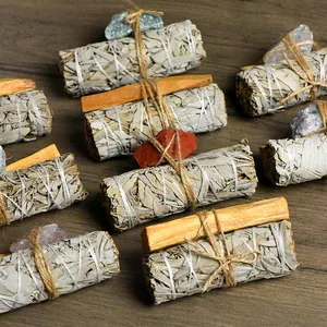 Natural white sage smudge bundles with palo santo sticks and raw natural healing crystals