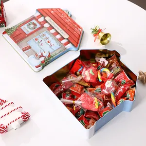Christmas house-shaped tin storage box filled with festive candies and sweets