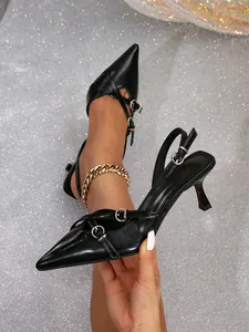 Close-up of black pointed-toe kitten heels featuring double buckle straps and slingback design