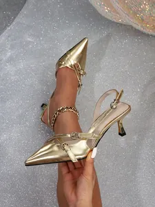 Detailed view of gold pointed-toe slingback high heels featuring double buckle straps