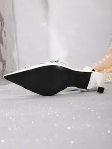 Vista detallada de la suela de zapato de tacón blanco con punta fina y marca de talla 37