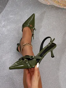 Detailed view of olive green pointed-toe kitten heels with cross straps and buckle details