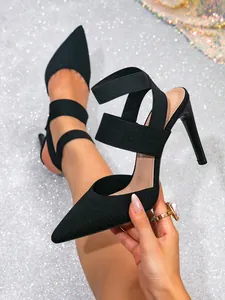 Close-up of black knit pointed-toe stiletto heels with elastic straps and sleek design.