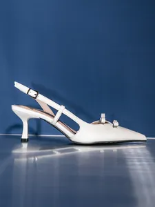 Detail view of white pointed-toe kitten heels with double bow and slingback strap
