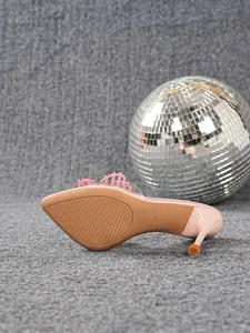 Detailed view of the anti-slip sole and wine glass heel of a pink pointed shoe