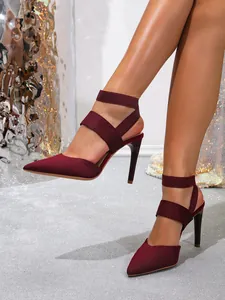 Close-up detail of burgundy knit pointed toe stilettos featuring multiple elastic straps