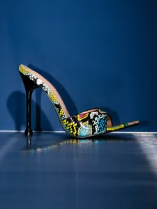 Side view of vibrant colorful snake print high heel sandal with stiletto heel