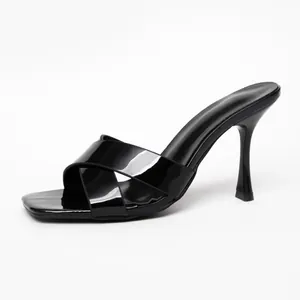 Elegant black patent leather high-heeled mules with cross straps and square toe