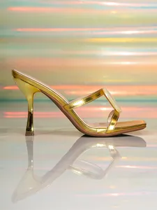 Side view of gold metallic high-heel sandals with square toe and shell ornament