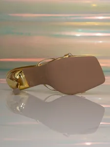 Detailed view of the gold square-toe high heel sandal sole with the size 37 stamp