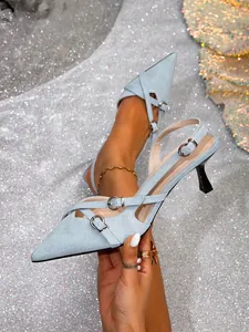 Detalle de los zapatos destalonados de mezclilla azul claro con punta y hebillas