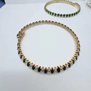 Close-up of vintage geometric oval zircon necklace with gold-plated stones