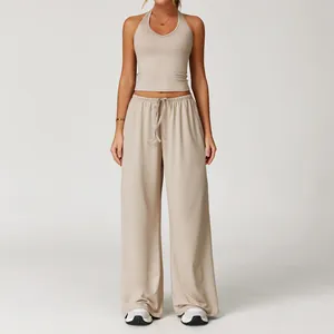 Two-piece brushed beige yoga set featuring a halter top and wide-leg trousers.