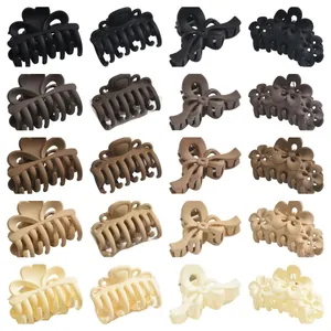 Set of matte hair claw clips in neutral coffee shades and various elegant styles.