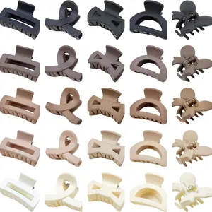 Assorted set of matte neutral hair claw clips in various classic shapes and earthy tones