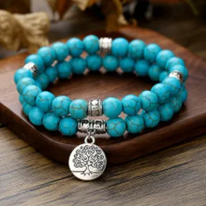 Close-up of bohemian double-layer turquoise beaded bracelet with tree of life pendant