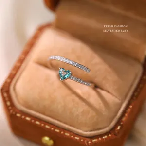 Detailed macro view of S925 sterling silver ring with blue heart gemstone in a velvet box