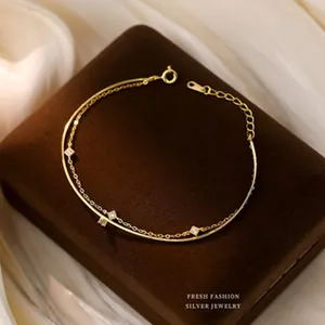 Close-up of elegant gold-plated silver bracelet with sparkling diamond-shaped charms