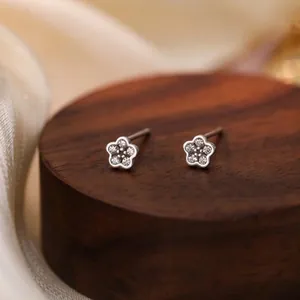 Macro view of S925 sterling silver flower stud earrings with sparkling zircon stones