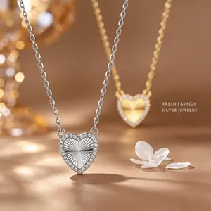 Close-up of s925 silver and gold heart necklaces featuring a radiant sunburst pattern
