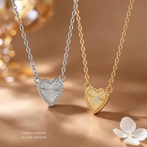 Detailed view of elegant S925 silver and gold heart necklaces with radiant sunburst design