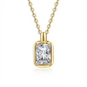 Macro view of gold-plated moissanite necklace featuring emerald-cut clear gemstone