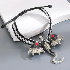 Detailed view of handmade woven dragon bracelet with sparkling enamel and rhinestone accents
