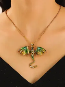 Close-up detail of a vintage dragon pendant necklace with green enamel and crystals.