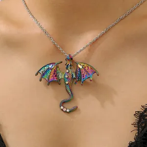 Close-up of a colorful iridescent dragon pendant necklace with rhinestones on a model's neck.