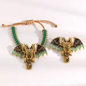 Detailed view of vintage enamel twin dragon bracelet and matching brooch set.