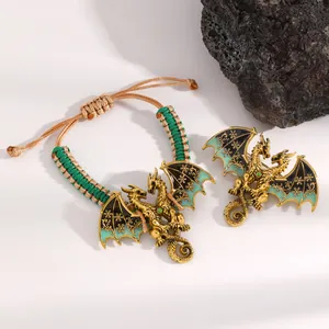 Detailed view of vintage enamel dragon woven bracelet and matching dragon brooch set.