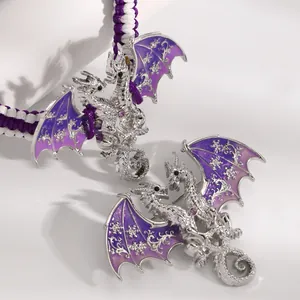 Detailed macro shot of silver dragon bracelet with purple enamel wings and woven cord