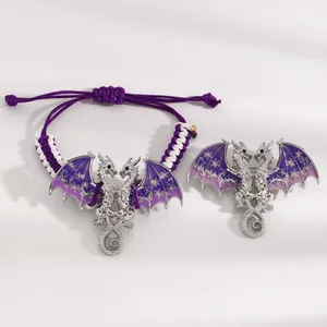 Detailed macro shot of vintage purple enamel dragon bracelet and matching brooch set.