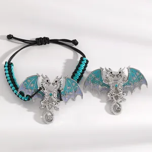 Detailed view of a vintage two-headed dragon bracelet and brooch with blue enamel wings.