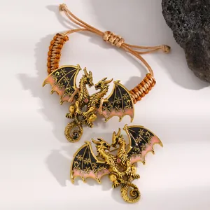 Detail view of vintage enamel dragon handmade woven bracelet and matching dragon brooch